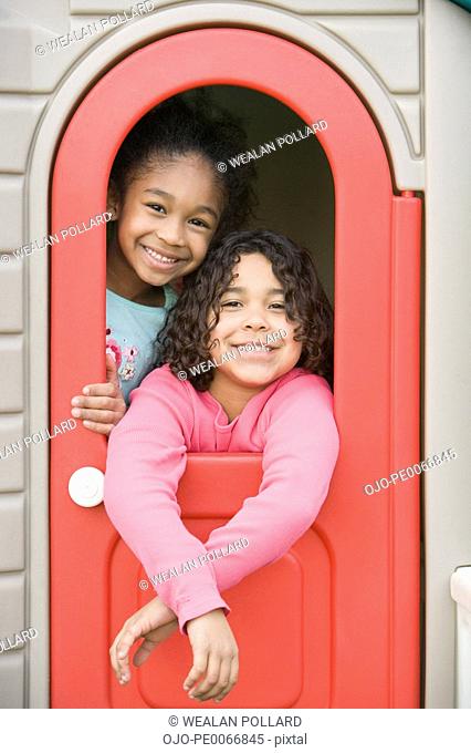 Girls inside playhouse