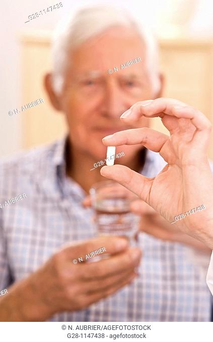 nurse  hands giving a  senior man his drug
