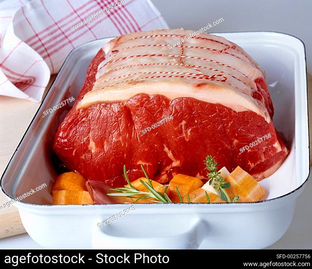 Raw roast beef in roasting dish