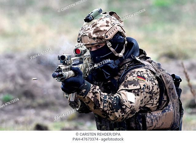 German Navy frogman shoots with his rifle during a military presentation in Eckernfoerde, Germany, 5 April 2014. .The undersea divers company celebrated its...