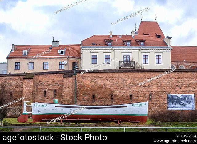 Passenger boat called Katarzynka in front of medieval walls of Old Town of Torun, Kuyavian Pomeranian Voivodeship of Poland