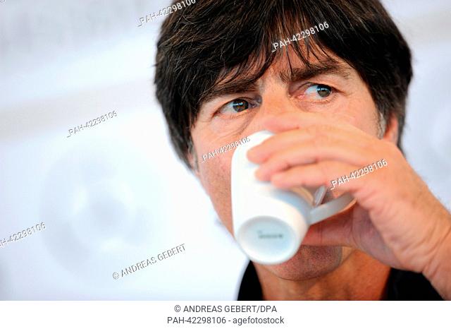Head coach of the German national soccer team Joachim Loew drinks at a press conference of the German team in Munich, Germany, 04 September 2013