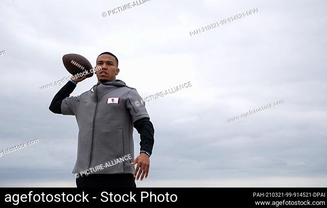 FILED - 09 February 2021, US, Newport Beach: Amon-Ra St. Brown throws a football on the beach. The American football player from the University of Southern...