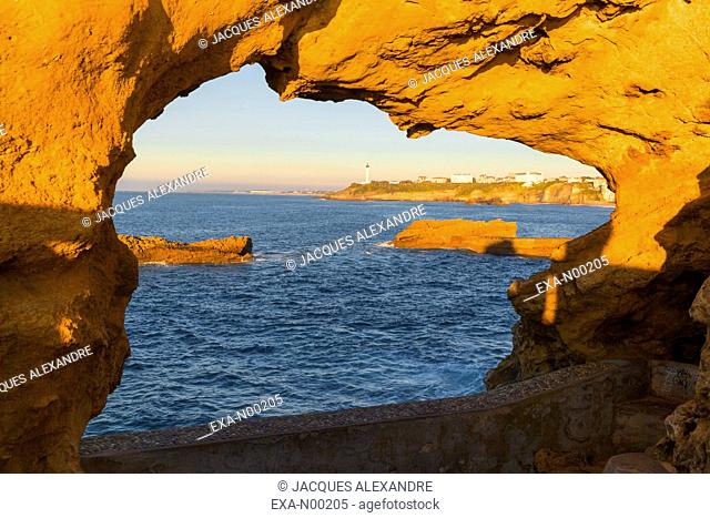 Bay of Biarritz at evening through a hole rock , France