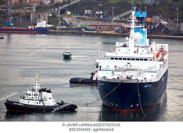 Berthing. Tugboat and cruise liner. Passenger ship. Tug maneuvers. Pasaia Port. Gipuzkoa. Basque Country. Spain. Europe