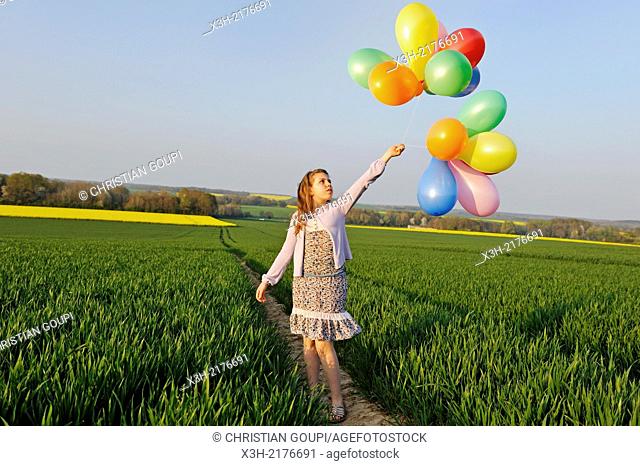 little girl playing with balloons in the fields, Eure-et-Loir department, Centre region, France, Europe