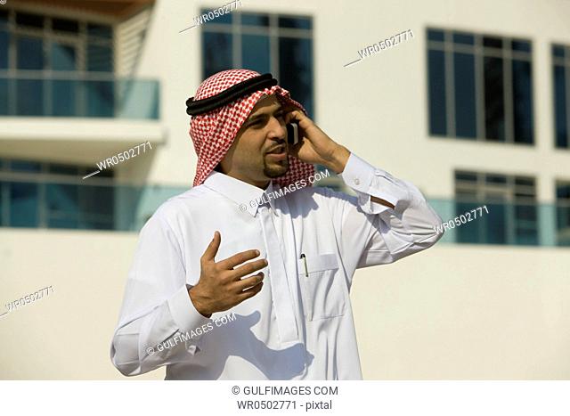 Arab businessman talking on Cellphone, standing