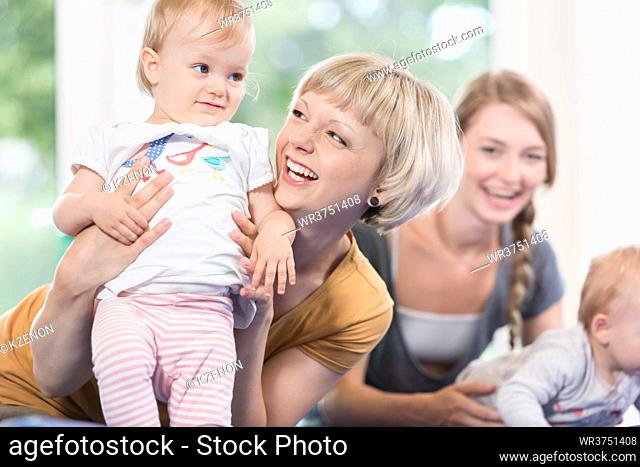 Young moms and their little children in mother and child course