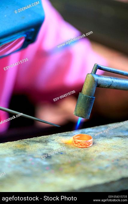 Goldsmith working with a thai traditional ring