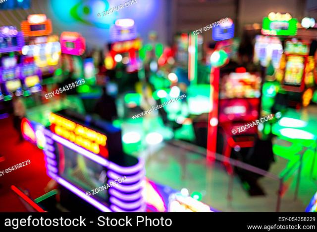 Blurry image of slots machines and other gambling equipment at a casino. Out of focus (bokeh) colourful and high contrast picture in a casino