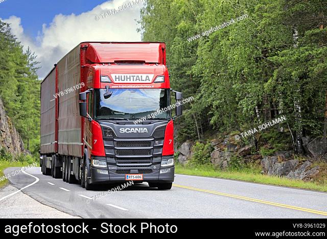 Red Next Generation Scania R650 truck Huhtala pulls freight trailer on highway on a sunny day of summer. Salo, Finland. July 6, 2019