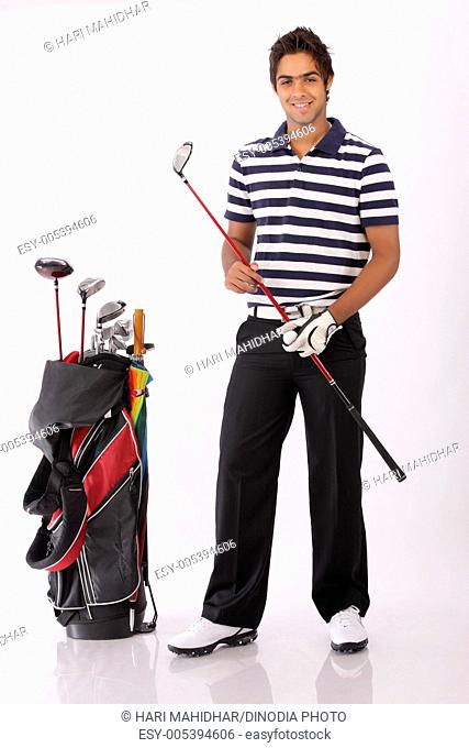Portrait of a golfer with golf kit ; India MR372