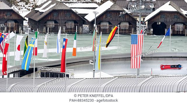 The four-person Bob with Drazen Silic and his team from Croatia passing the echo-curve lined with flags in Schoenau Am Koenigssee, Germany, 22 February 2017