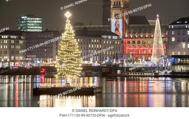 The Christmas tree in the middle of the Binnenalster river, also called 'Alstertanne', is illuminated in Hamburg, Germany, 30 November 2017