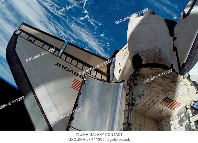 Backdropped by a blue and white section of Earth and the blackness of space, Space Shuttle Endeavour's starboard wing, a portion of its payload bay and part of...