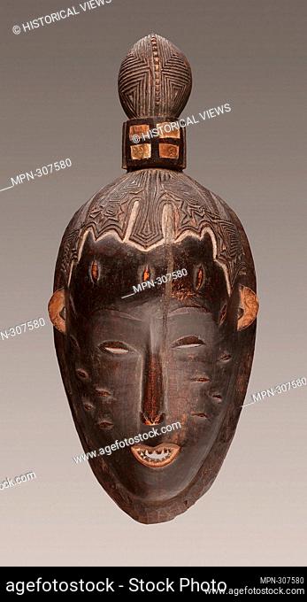 Guro. Female Face Mask (Gu)-Early 20th century-Guro Cte d-Ivoire Coastal West Africa. Wood and pigment. 1900-1925