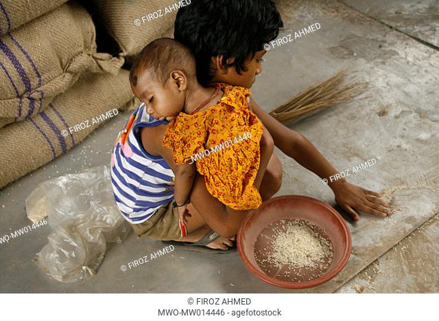 A girl collects leftover rice at Badamtoli wholesale market The daily necessities have gone beyond the reach of the poor due to spiraling prices Dhaka