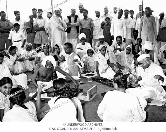 New Delhi, India: April 19, 1946.Mahatma Gandhi and Pandit Jawaharlal Nehru participate in a charkha demonstration held in the Bhangi colony in New Delhi in...
