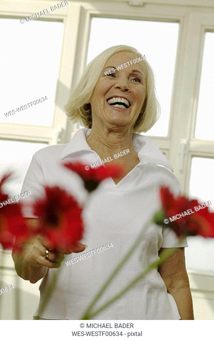 Senior woman laughing, looking away, portrait