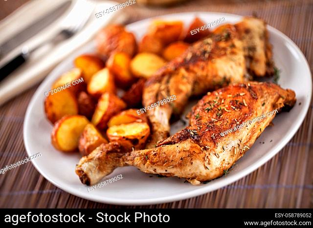 Roast Chicken Thighs with Potatoes on a Plate