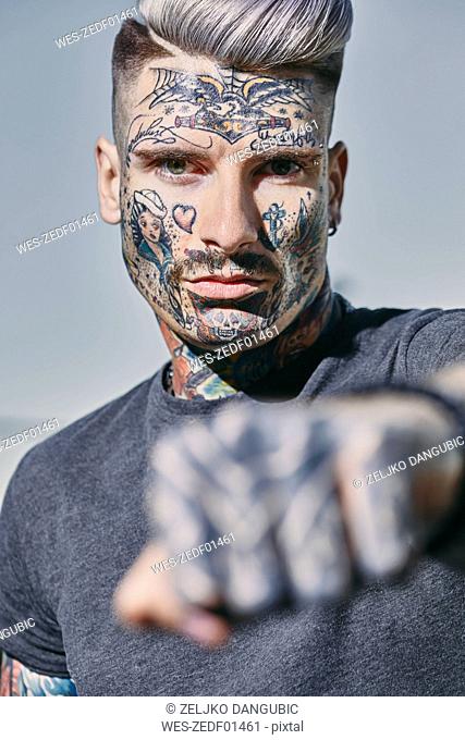 Portrait of tattooed young man outdoors clenching his fist, Stock Photo,  Picture And Royalty Free Image. Pic. WES-ZEDF01461 | agefotostock