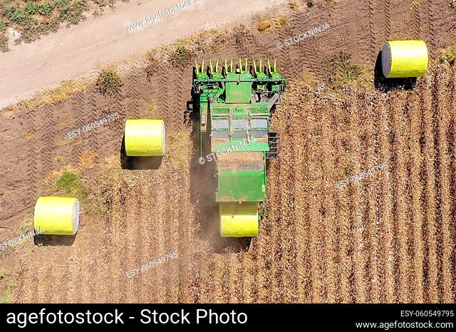 Top down aerial image of a Large Cotton picker harvesting a field
