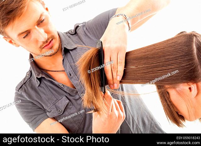 Professional hairdresser with long hair model, isolated on white background