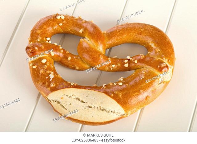 A pretzel is a type of baked bread product made from dough most commonly shaped into a knot