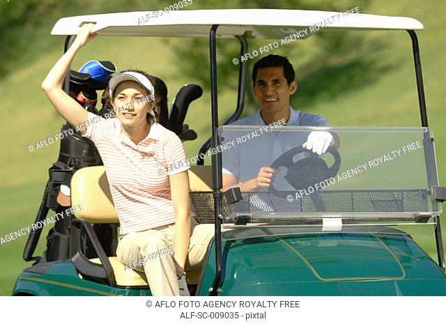 Couple resting in a golf cart