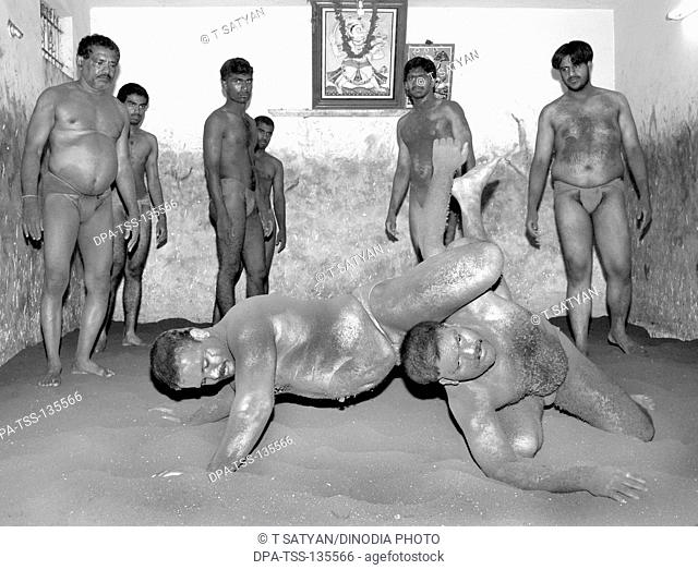 Men practicing Nada kushti  ; traditional Indian wrestling ; Mysore ; Karnataka ; India