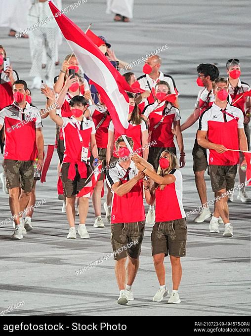 23 July 2021, Japan, Tokio: Olympia: Opening ceremony in the Olympic Stadium. The Austrian team with the flag bearers Tanja Frank and Thomas Zajac enters the...