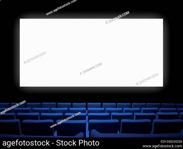 Cinema movie theatre with blue velvet seats and a blank white screen. Copy space background
