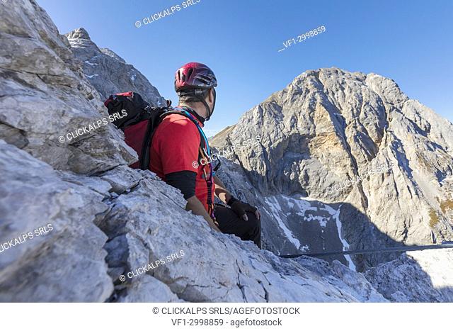 Mountaineer along the via ferrata on the north side of mount Gr. Kinigat, Kartitsch, East Tyrol, Austria, Europe