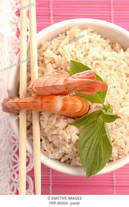 Bowl filled with rice and prawns on top