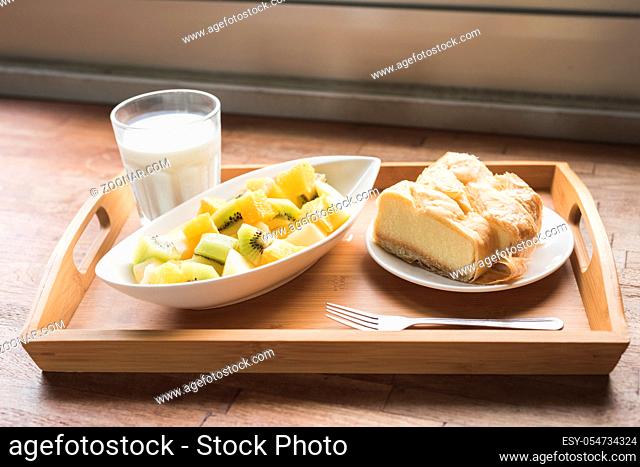breakfast with milk, fruit and cake at morning