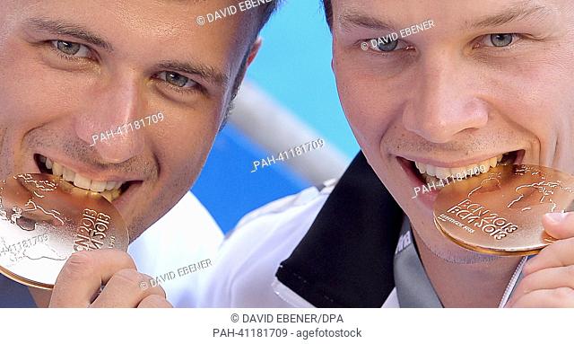 Sascha Klein (L) and Patrick Hausding of Germany pose with their gold medals after winning the men's 10m Synchro Platform diving final of the 15th FINA Swimming...