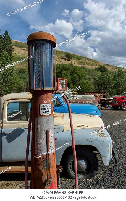 Antique gas pump and cars at an old gas station, part of an old car collection at a farm near Colfax in Whitman County in the Palouse, Washington State, USA