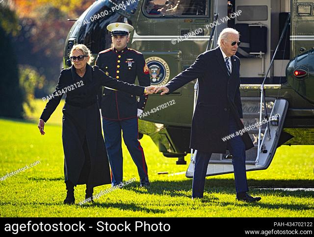 United States President Joe Biden and first lady Dr. Jill Biden hold hands on the South Lawn of the White House after arriving on Marine One in Washington, DC