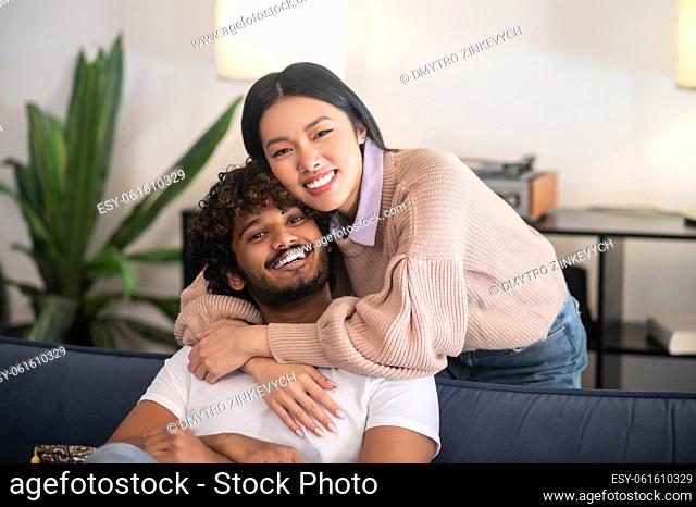 Happy couple. Two young people hugging and looking happy and cheerful