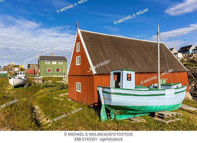 Brightly painted houses and boat in Sisimiut, Greenland