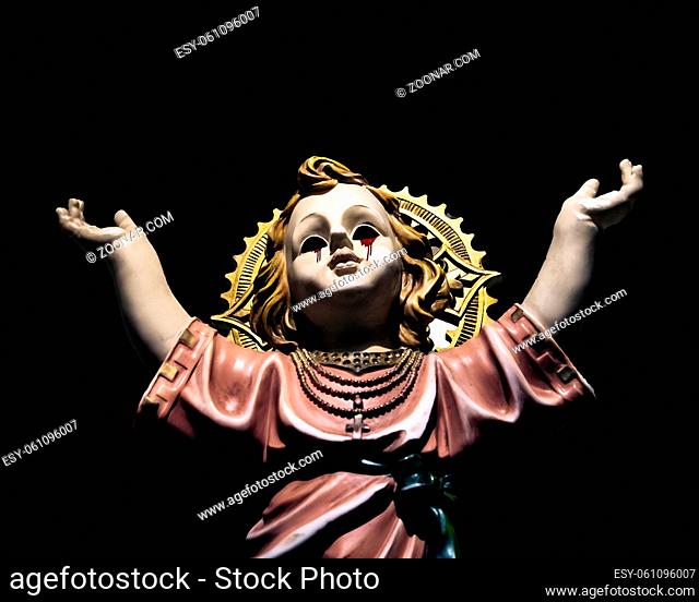 Creepy art depicting angel boy crying blood with hans up looking at the sky over black background