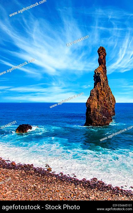 Two huge scenic rocks near the pebble beach. Magic travel on the volcanic island of Madeira. Concept of exotic and ecological tourism