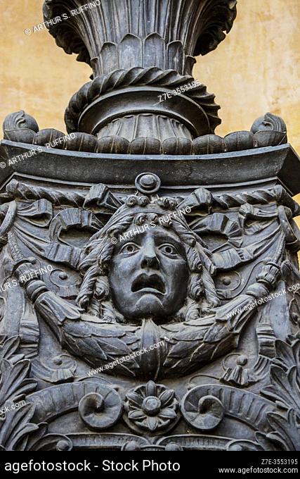 Sculptural relief on the base of one of the bronze lanterns in niches in the portico of the main entrance to Massimo Theater (Teatro Massimo)