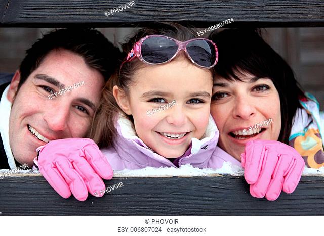 parents and their daughter in the mountains