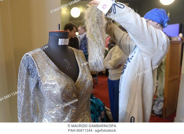 Visitors and customers examine costumes for sale in the props and dressing room of the Komische Oper Berlin in Berlin, Germany, 3 February 2013