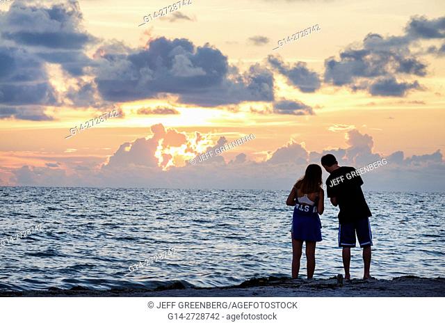 Florida, Gulf of Mexico, Gulf Coast, Anna Maria Island, Bradenton Beach, beachfront, sunset, ocean, water, girl, boy, teen, couple