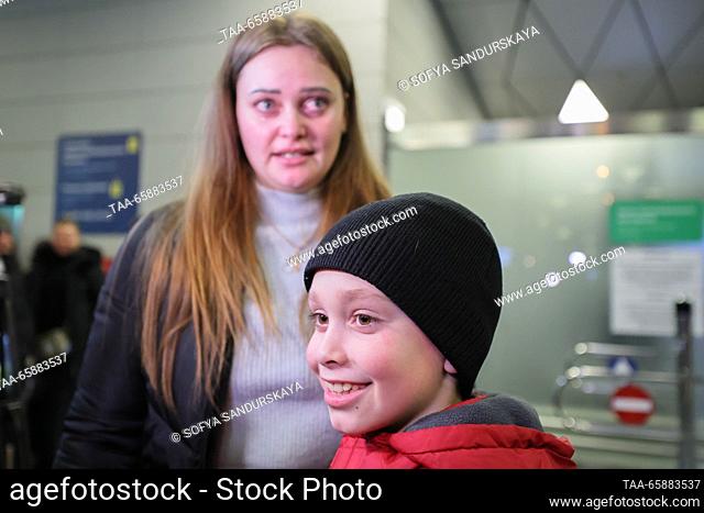 RUSSIA, MOSCOW - DECEMBER 19, 2023: Alexandra Zhulina and her son Nikita Artemichev who has arrived on an Istanbul-Moscow flight