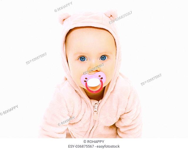 Closeup portrait of sweet baby with pacifier on a white background