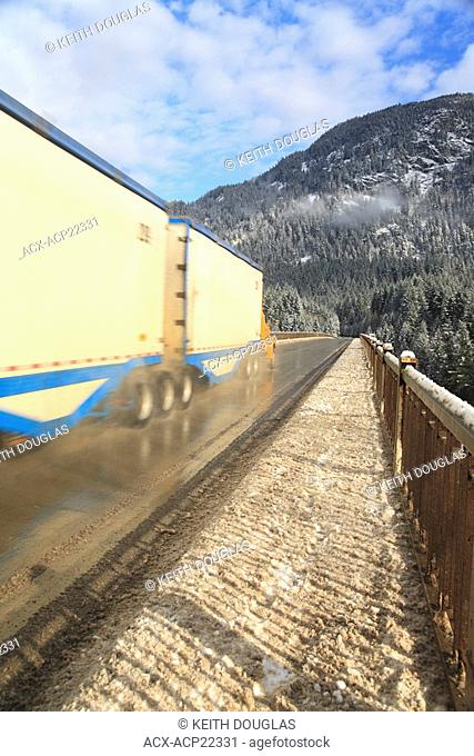 Transport truck on Hwy 97 in Fraser Canyon crossing Alexandria Bridge over the Fraser River, near Hope, British Columbia