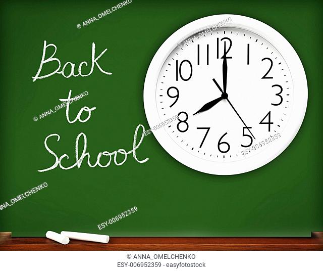 Back to school concept, handwriting on a green chalkboard with big white clock.